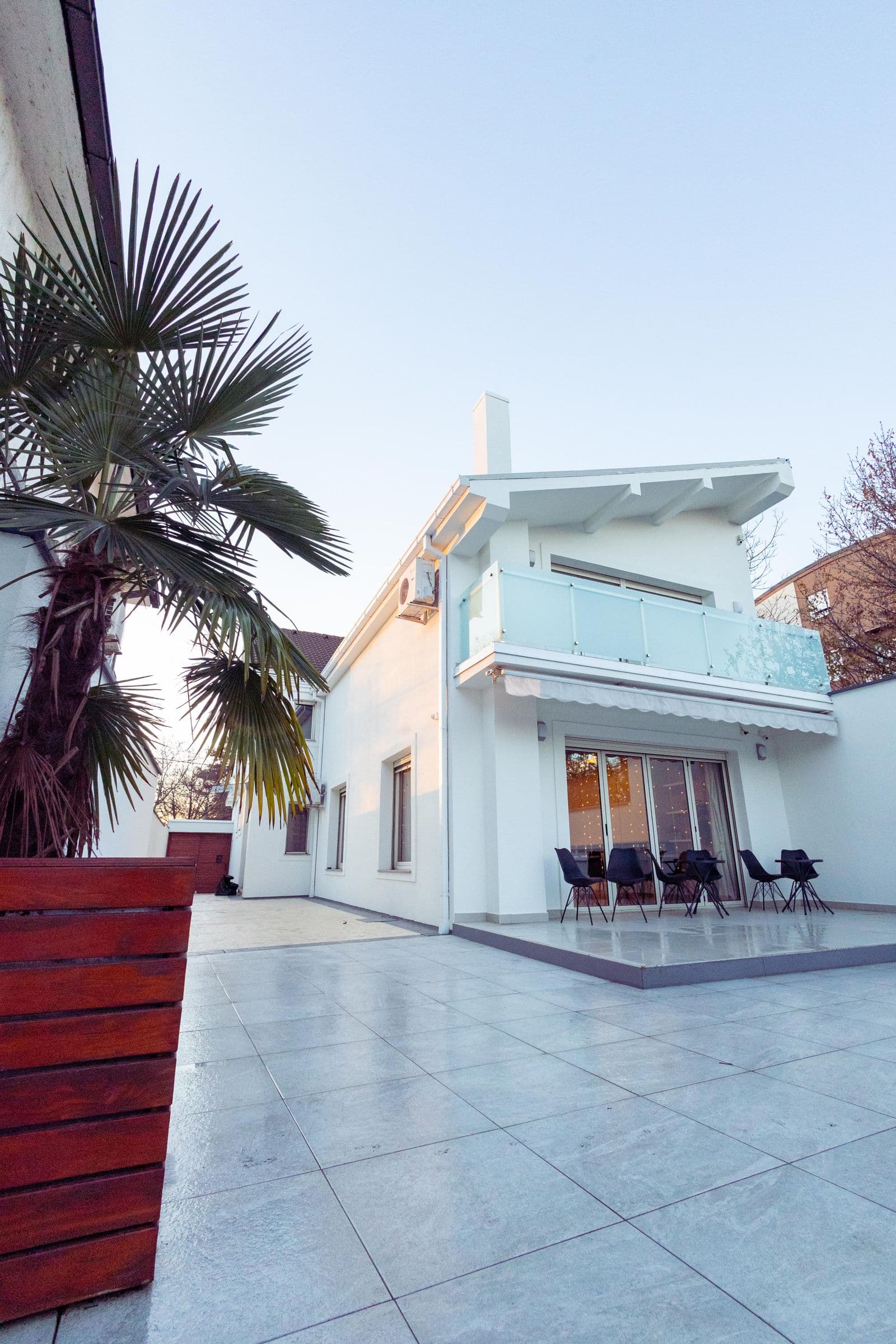 Contemporary luxury home with large glass windows and landscaped yard