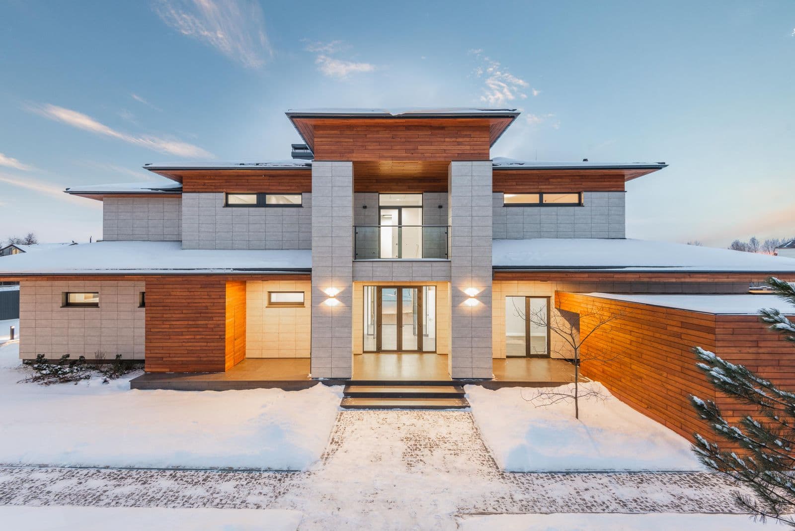 Modern two-story house exterior with stylish facade and driveway